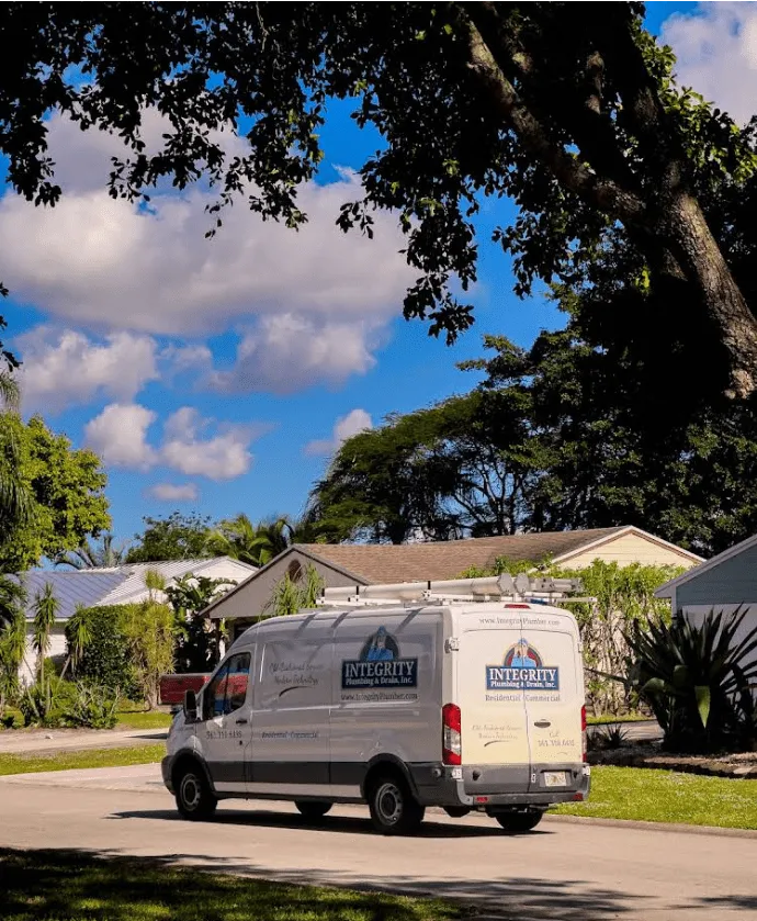 Integrity Plumbing and Drain service van parked outside a West Palm Beach home